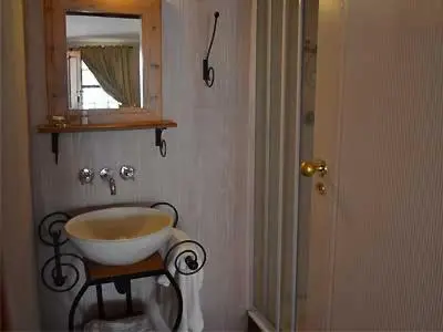 a bathroom with a bowl sink and a mirror at The Pennefather in Haenertsburg