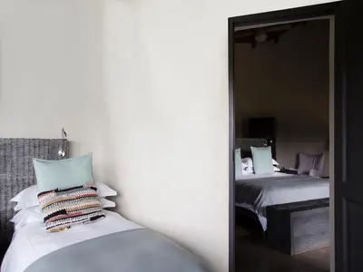 a mirror reflection of a bedroom with two beds at Simbavati River Lodge in Timbavati Game Reserve