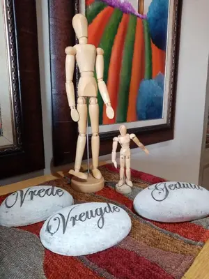 a mannequin standing on three rocks next to a painting at Ridderspoor Guesthouse in Middelburg