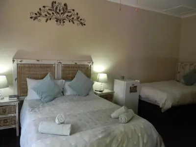 a bedroom with two beds with towels on them at Ridderspoor Guesthouse in Middelburg