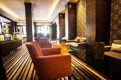 a lobby with couches and chairs and a bar at Southern Sun Pretoria in Pretoria