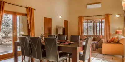 a dining room with a table and chairs at Warthogs Rest in Hoedspruit