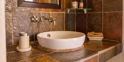 a bathroom with a large white tub on a counter at Warthogs Rest in Hoedspruit
