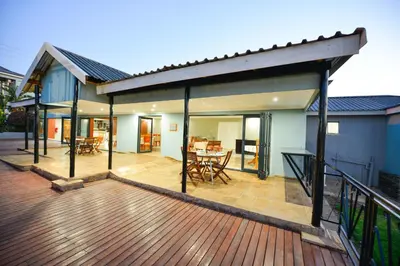 a house with a deck with a table and chairs at Serurubele Boutique Hotel in Bushbuckridge