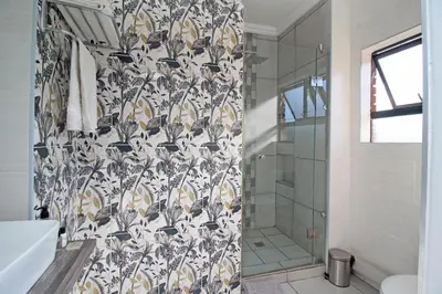 a bathroom with a shower and a shower curtain at The Chameleon in Centurion