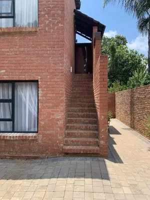 a brick building with stairs on the side of it at The Chameleon in Centurion