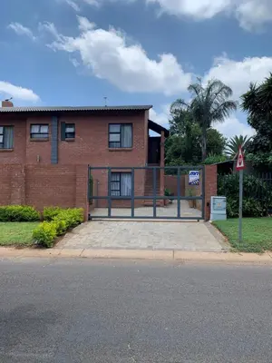 a brick building with a gate in front of it at The Chameleon in Centurion