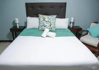 a bedroom with a bed with two towels on it at Gracious Lodge in Burgersfort