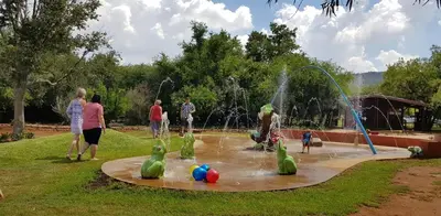a group of people playing in a water park at Die Plasie on-suite rooms in Hartbeespoort