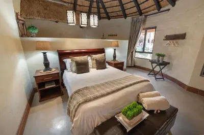 a bedroom with a large bed in a room at Malilule Safaris in Hoedspruit