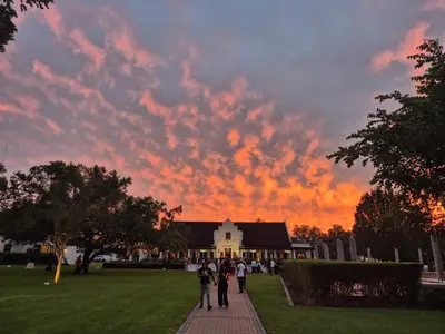a group of people walking down a sidewalk in front of a building at Kievits Kroon Gauteng Wine Estate in Pretoria