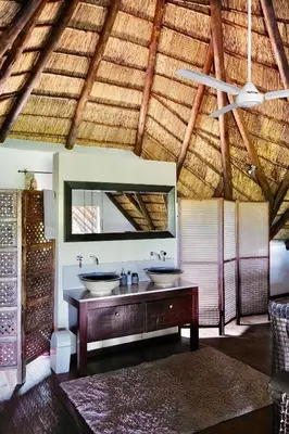 a bathroom with two sinks and a ceiling at Rhinos Rest in Marloth Park