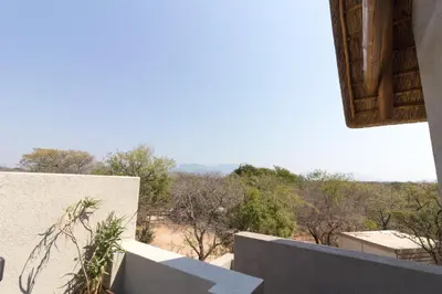 a view of the desert from the balcony of a house at Vuyani Safari Lodge in Hoedspruit
