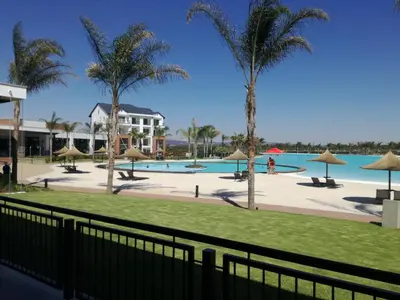 a view of the pool at the resort at The Blyde - Crystal Lagoon Penthouse Apartment in Pretoria