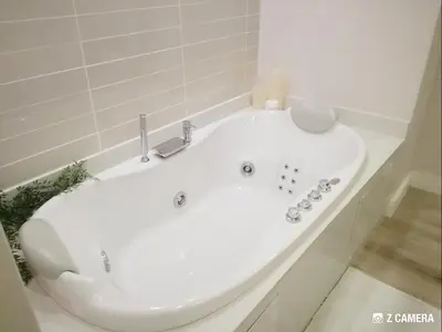 a white bath tub in a white bathroom at The Blyde - Crystal Lagoon Penthouse Apartment in Pretoria