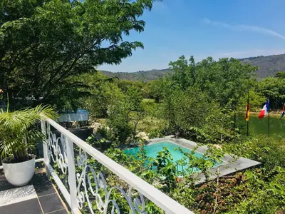 a balcony with a view of a swimming pool at Ashbourne Country Escape Hazyview in Hazyview