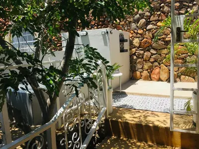 a staircase leading to a bathroom with a refrigerator at Ashbourne Country Escape Hazyview in Hazyview