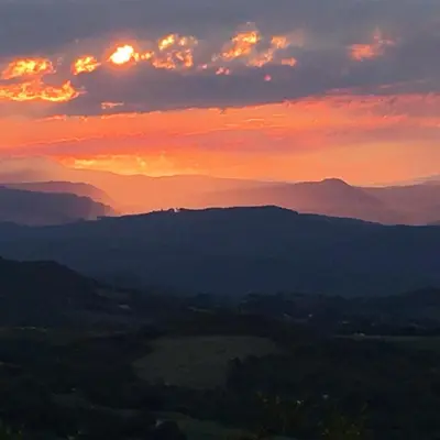 a sunset over a valley with mountains in the background at Ashbourne Country Escape Hazyview in Hazyview