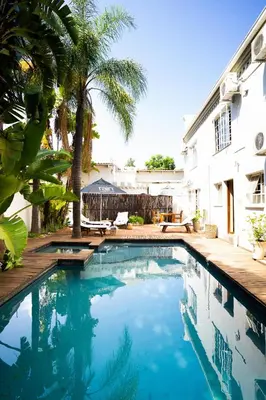 a swimming pool in the backyard of a house at Village Ridge Stays in Pretoria