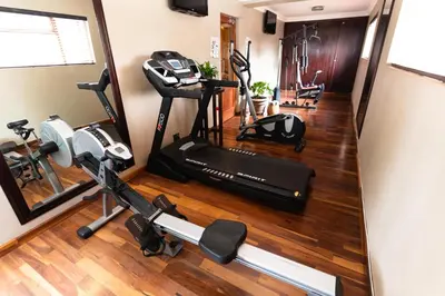 an overhead view of a gym with a treadmill and weights at Village Ridge Stays in Pretoria