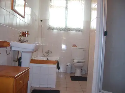 a white bathroom with a sink and a toilet at Oaktree Lodge Guest House in Kyalami