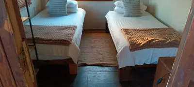 two twin beds in a small room with at Hippo Retreat & Tiger Fishing Komatipoort in Komatipoort