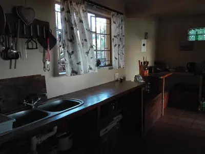 a kitchen with a counter and a sink and a window at Hippo Retreat & Tiger Fishing Komatipoort in Komatipoort