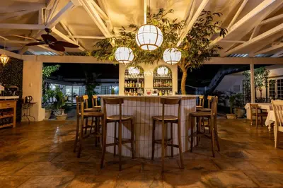 a bar in a restaurant with chairs and lights at Shandon Lodge Guest House & Spa in Nelspruit