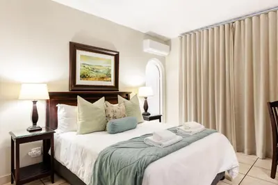 a bedroom with a bed with two towels on it at Shandon Lodge Guest House & Spa in Nelspruit