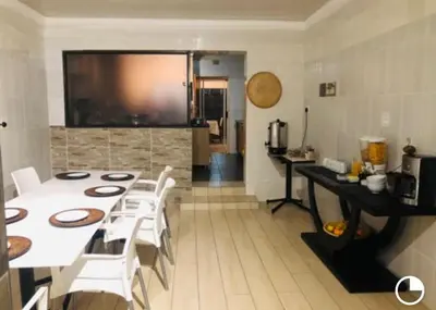 a dining room with a white table and white chairs at Ankuweni Guest house in Giyani