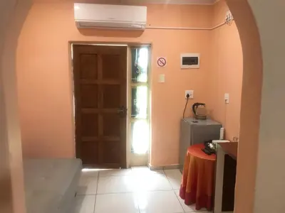 a hallway with a door and a table in a room at Ankuweni Guest house in Giyani