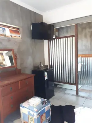 a room with a kitchen with a dresser at Oppermans Villa in Pretoria