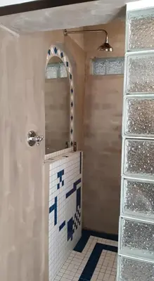 a bathroom with a shower with a mirror and a door at Oppermans Villa in Pretoria