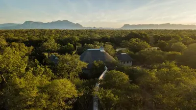 an aerial view of a house in the middle of a forest at Vuyani River Lodge in Hoedspruit