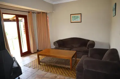 a living room with a couch and a coffee table at Field and Stream in Dullstroom