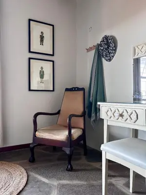 a chair sitting in a living room next to a table at Bateleur Nature Reserve & Stamvrug Hiking Trails in Modimolle