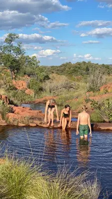 a group of people in the water in a river at Bateleur Nature Reserve & Stamvrug Hiking Trails in Modimolle