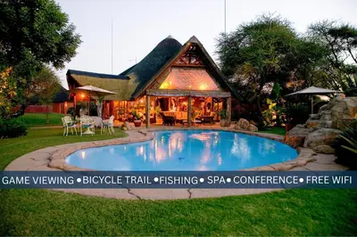 a house with a swimming pool in the yard at Ditholo Game Lodge Bela Bela in Bela-Bela