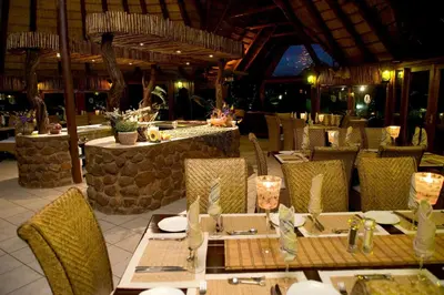 a dining room with a table and chairs in a restaurant at Ditholo Game Lodge Bela Bela in Bela-Bela
