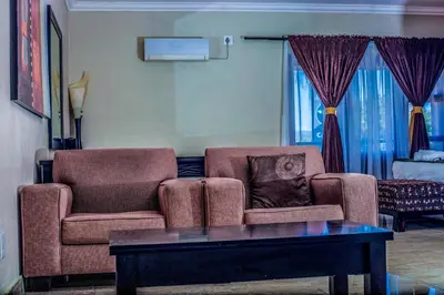 a living room with two chairs and a coffee table at Coyotes Hotel & Conference Centre in Nelspruit