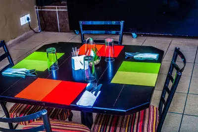 a table with colorful napkins and utensils on it at Coyotes Hotel & Conference Centre in Nelspruit