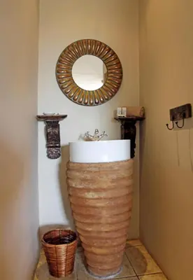 a bathroom with a sink and a mirror on the wall at Blue Grass Nest in Nelspruit