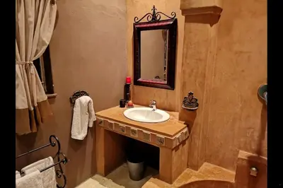a bathroom with a sink and a mirror at Blue Grass Nest in Nelspruit