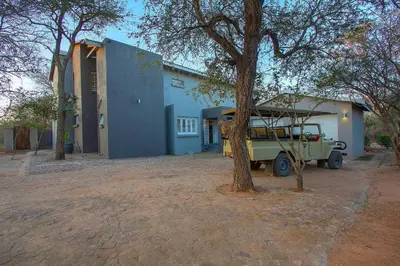 a truck parked in front of a blue building at 3433 on Klipspringer Marloth Park Kruger in Marloth Park