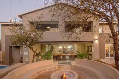 a house with a fire fountain in front of it at 3433 on Klipspringer Marloth Park Kruger in Marloth Park