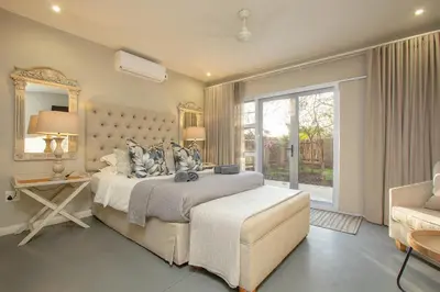 a bedroom with a large bed and a window at 3433 on Klipspringer Marloth Park Kruger in Marloth Park