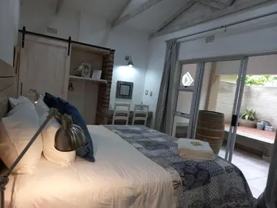a bedroom with a large bed in a room at Klipkoppie Cottage in Nelspruit