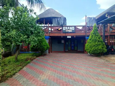 a building with a brick walkway in front of it at Elegant Guest House Malelane in Malelane