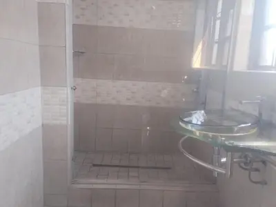a bathroom with a shower and a sink at Elegant Guest House Malelane in Malelane