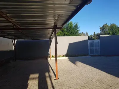 an empty building with awning on top of a patio at MZET GUEST HOUSE in Ermelo